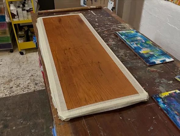 Blue oil painting in progress on reclaimed timber